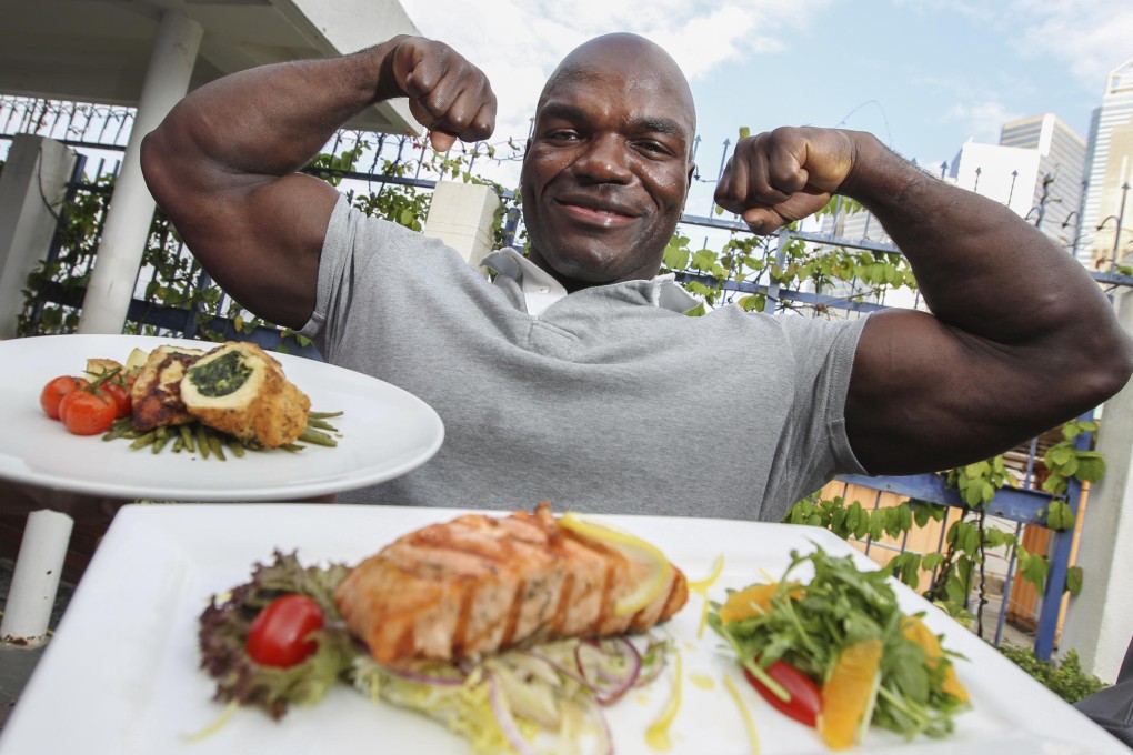 Alain Ngalani with his healthy options: salmon with orange (front); and mozzarella and spinach stuffed chicken breast. Photo: Nora Tam