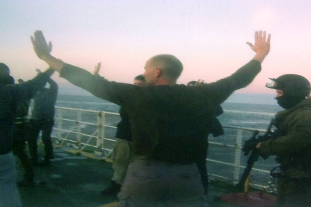 Greenpeace protesters are detained by Russian security. Photo: AP