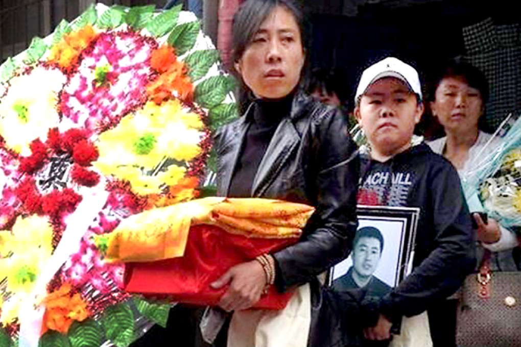 Zhang Jing, the widow of executed street hawker Xia Junfeng, leaves his funeral in Shenyang yesterday. Photo: SCMP