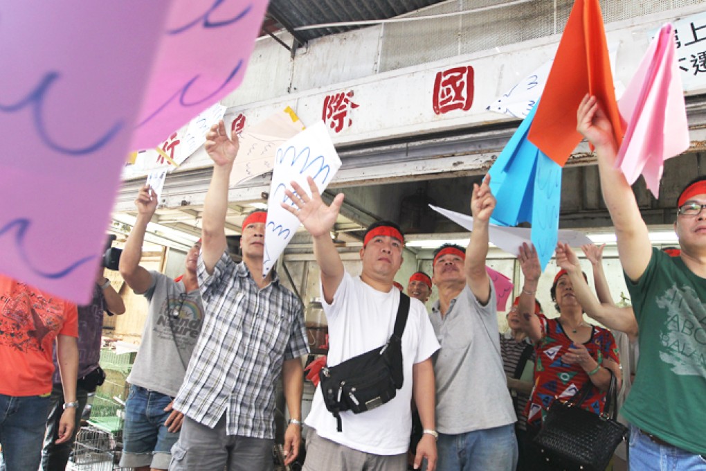 Eric Leung (second left) and other business owners protest against their eviction. Photo: Sam Tsang