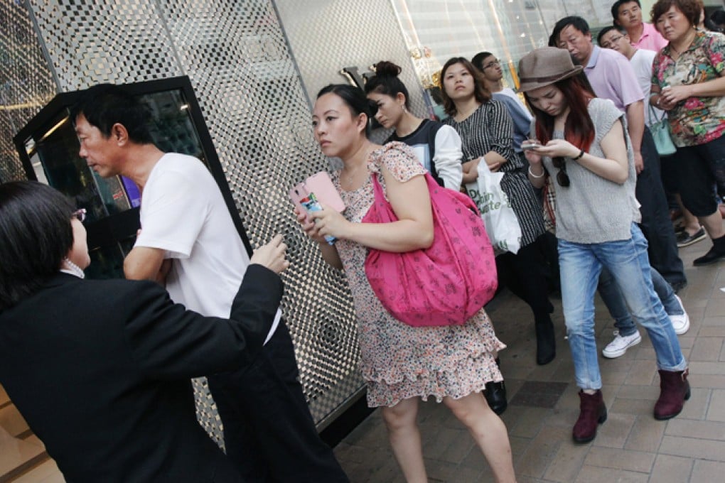 Shoppers from the mainland queue up outside a store in Tsim Sha Tsui on the second day of the "golden week" holiday. Photo: David Wong