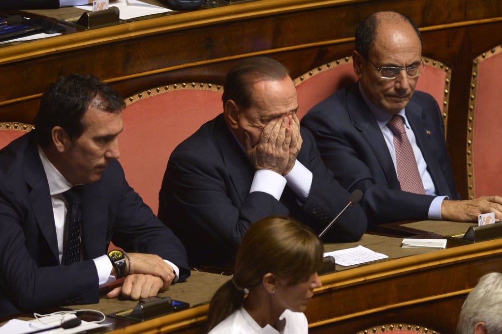 Italian ex-Prime Minister Silvio Berlusconi (C) is seen at the confidence vote site at the Senate in Rome, Italy, Oct. 02, 2013. Photo: Xinhua
