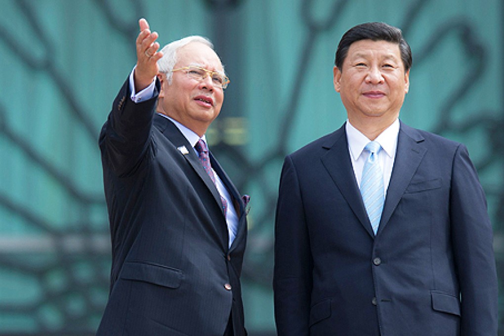 President Xi Jinping (right) stands with Malaysian Prime Minister Najib Razak during a photo call at the top steps of the prime minister's office in Putrajaya, Malaysia, on Friday. Photo: AFP