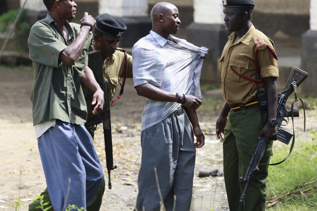Police detain youths after theprotest. Photo: Reuters