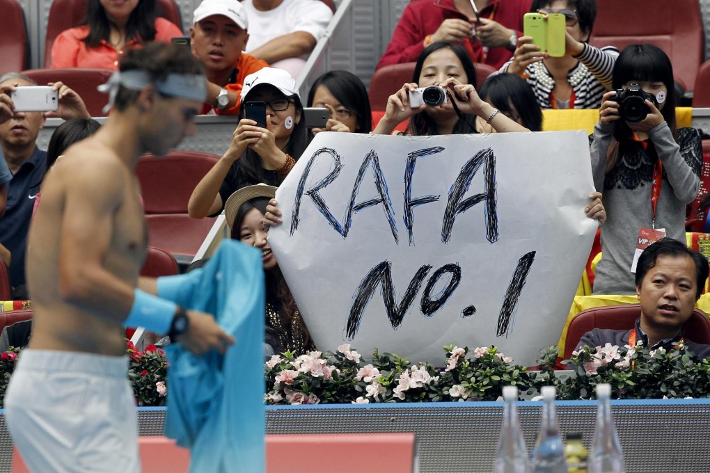 Fans hail Spain's Rafael Nadal as he walks back to his chair during his semi-final clash against Tomas Berdych in Beijing. Photo: EPA