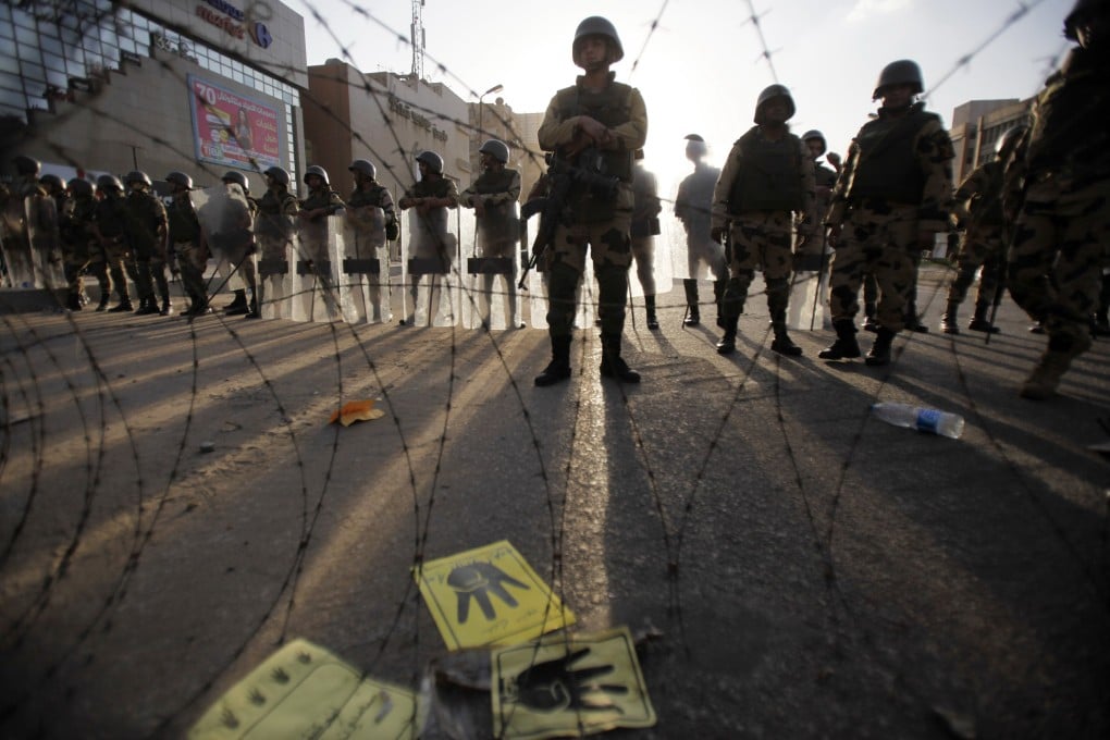 Egyptian soldiers stand guard in Cairo during a protest by members of the Muslim Brotherhood and supporters of ousted Egyptian President Mohamed Mursi on Friday. Photo: Reuters