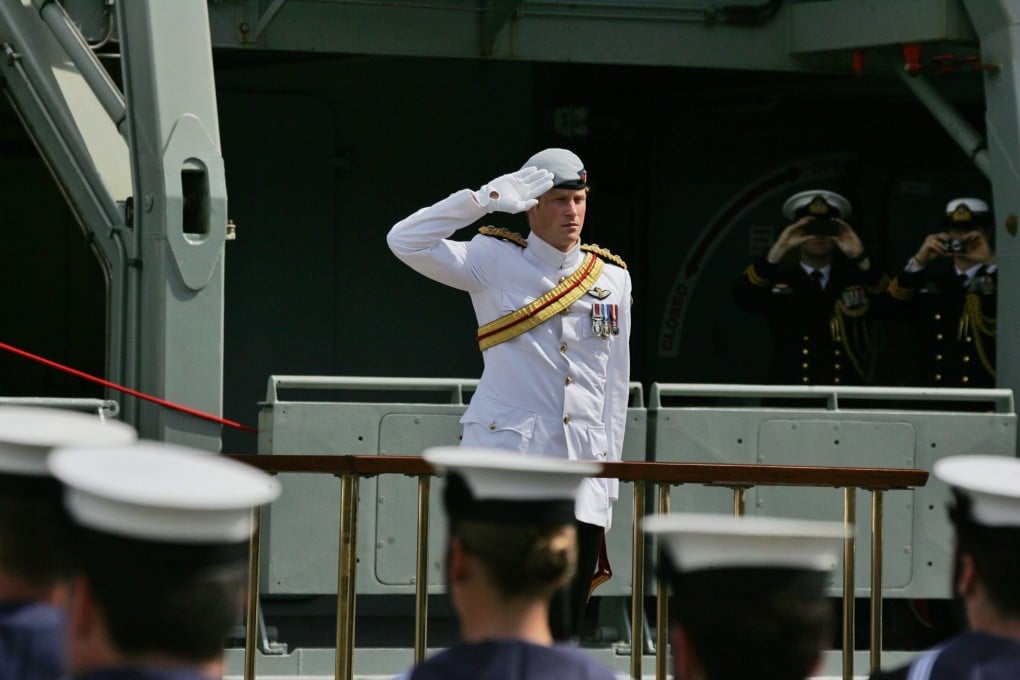 Prince Harry salutes the ceremonial guards at Garden Island Naval Base for the International Fleet Review in Sydney. Photo: EPA