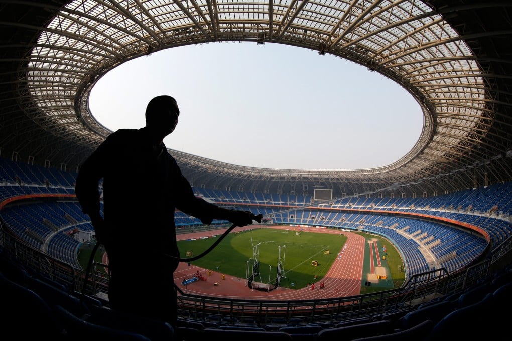 A worker cleans chairs ahead of the East Asian Games in Tianjin, China. Photo: EPA