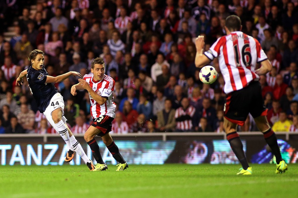 Manchester United's Adnan Januzaj (left) scores his goal past Sunderland's captain John O'Shea at the Stadium of Light. Photo: AP
