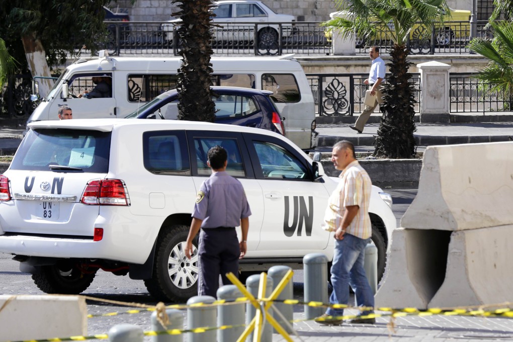 United Nations vehicles are seen leaving the hotel in Damascus. Disarmament inspectors from the UN and OPCW will destroy Syria's chmeical arsenal. Photo: AFP