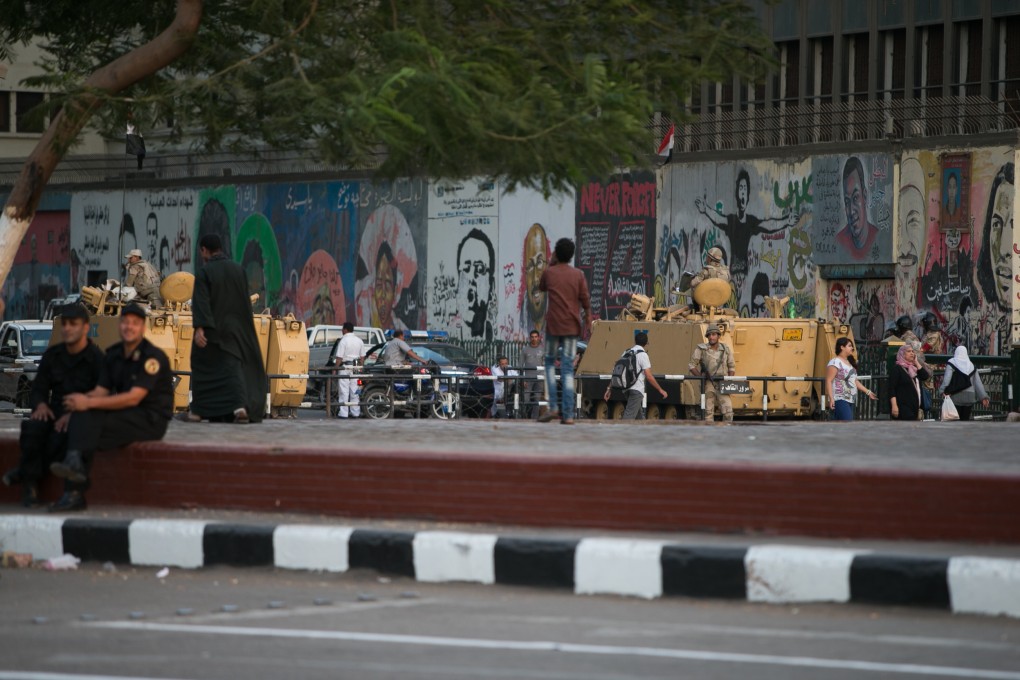 Armed vehicles guard an entrance of the Tahrir Square in Cairo, Egypt. Photo: Xinhua