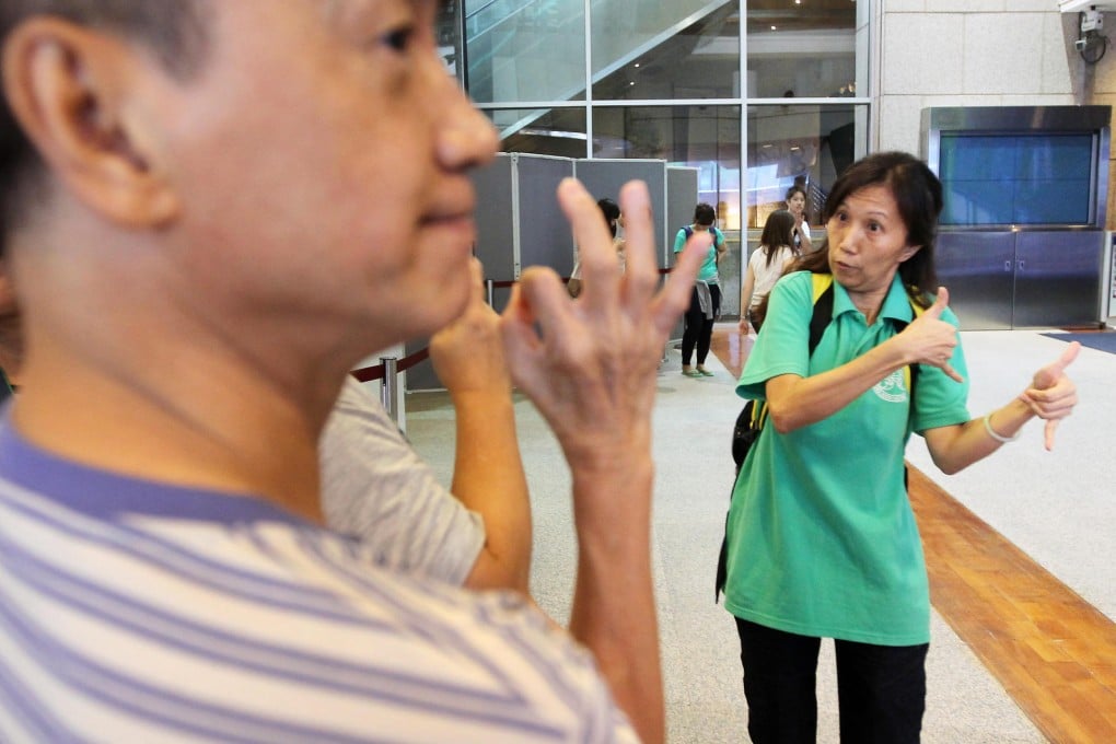 Mindy Lai (right) leads a deaf group on a visit to the Hong Kong Museum of History in Tsim Sha Tsui. Photo: Edward Wong
