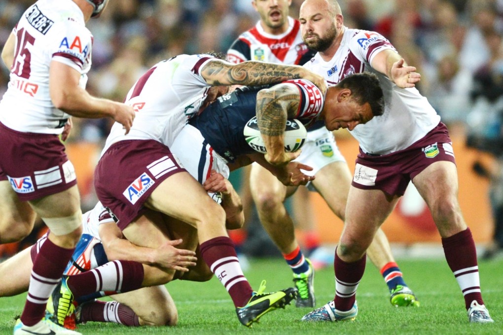 Sonny Bill Williams is tackled during the grand final between the Sydney Roosters and the Manly Sea Eagles in Sydney on Sunday. Photo: EPA