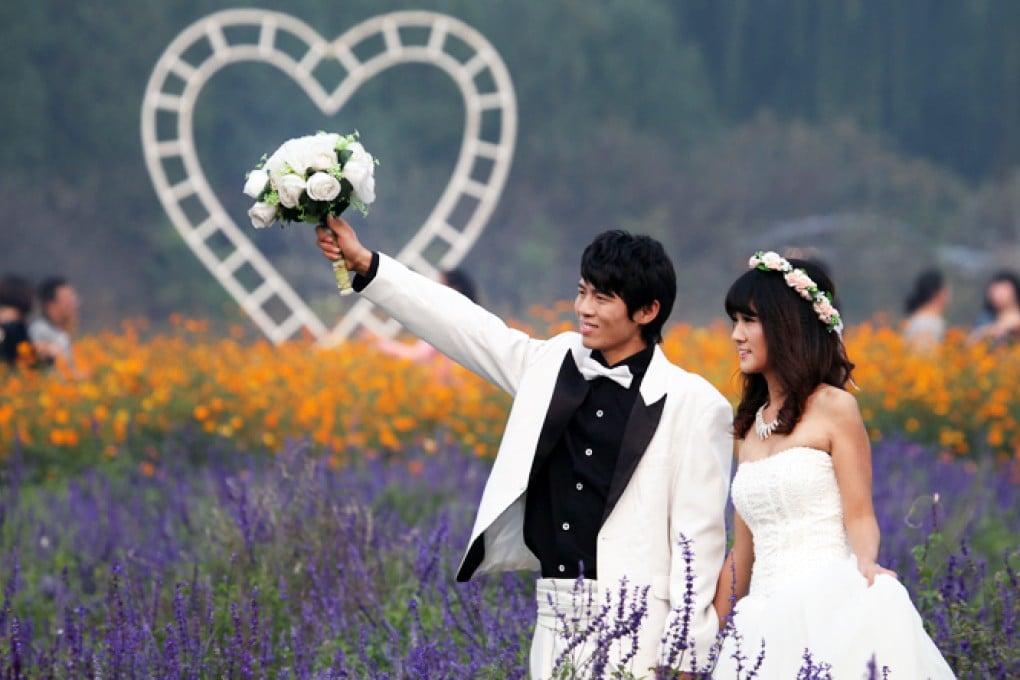 A newlywed couple pose for photos in a park on the outskirt of Beijing. Beijing official Ma Linxiang is being investigated after throwing a lavish three-day wedding for his son. Photo: Xinhua