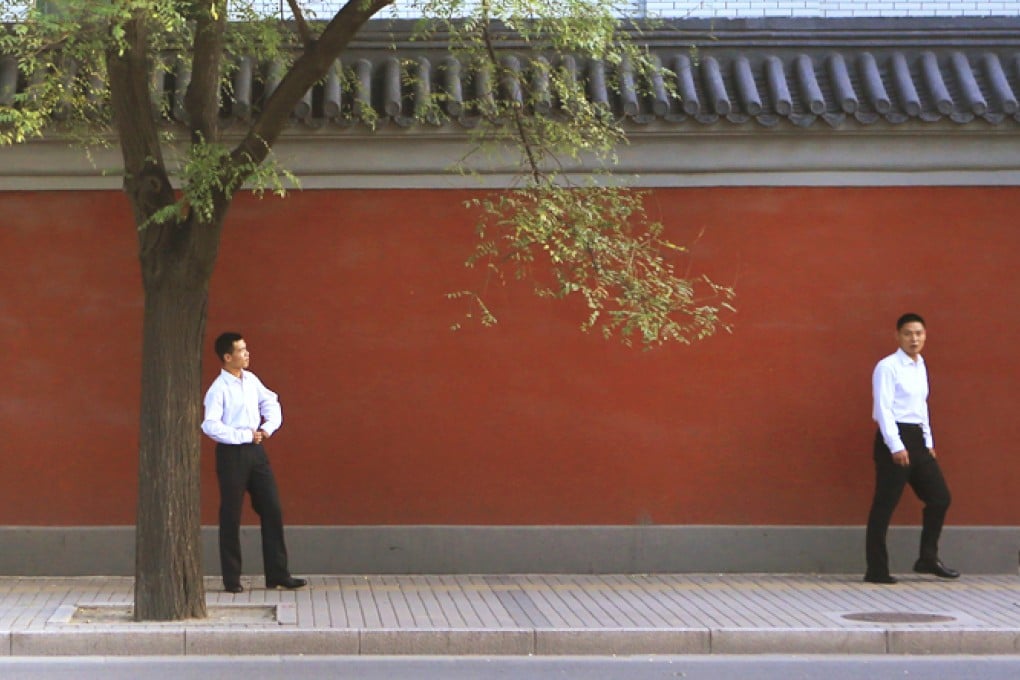 Security personnel patrol outside the Zhongnanhai leadership compound in the centre of Beijing. Photo: Reuters