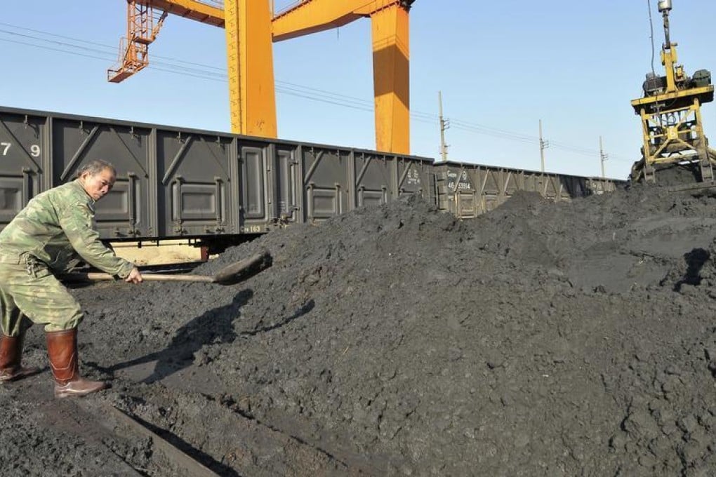 A man shovels tin in China. Yunnan Tin chairman Lei Yi is charged with taking 20m yuan in bribes. Photo: Reuters