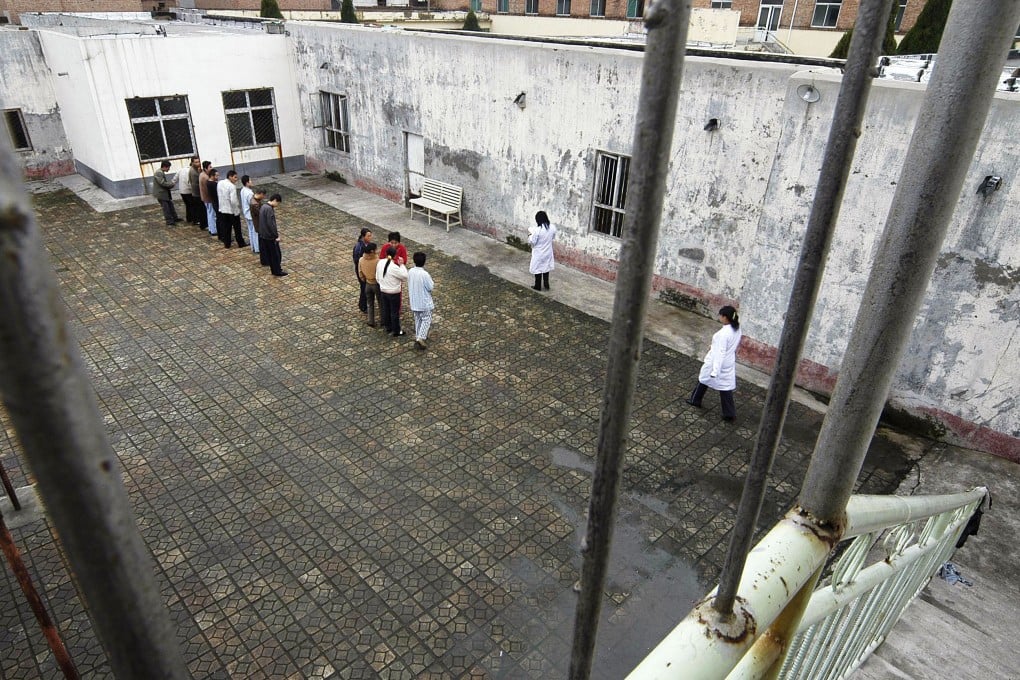 Patients stand at a yard inside a hospital which houses and provides treatment to about 40 patients who are suffering from mental illnesses, in Changzhi, Shanxi. Photo: Reuters