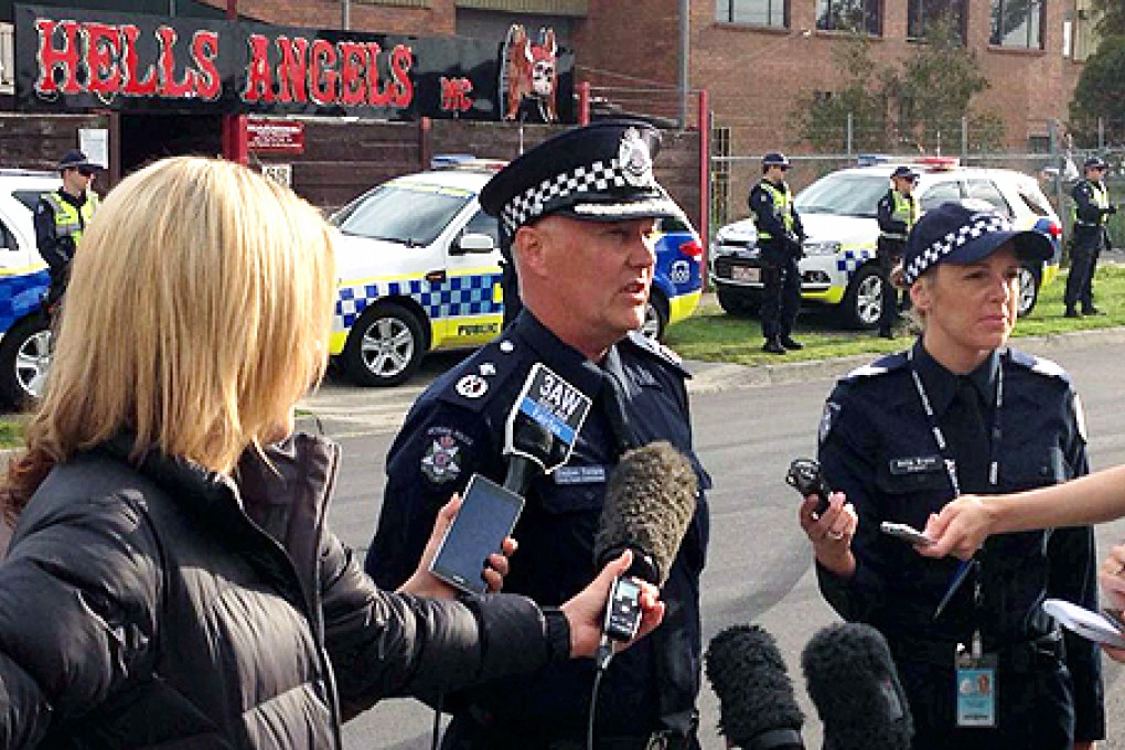 Acting Deputy Commissioner Steve Fontana of Victoria Police speaks to the media outside a Hells Angels property in Melbourne. Photo: AFP