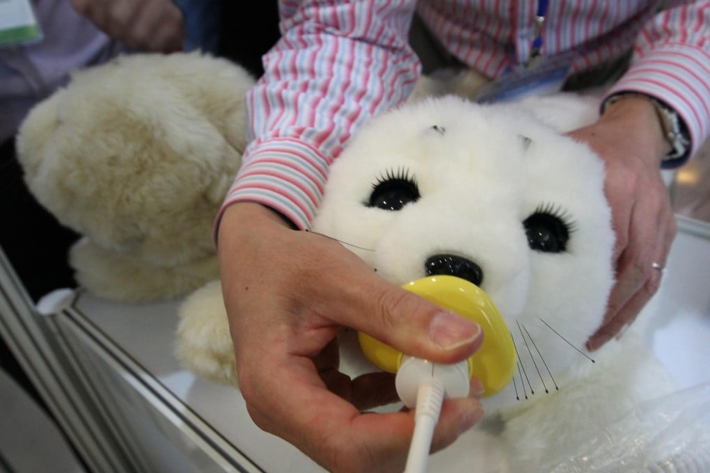 This robotic seal, named Paro, is helping dementia patients as a safe alternative to animal therapy. Photo: Felix Wong