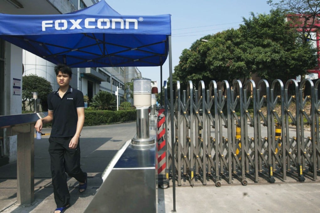 A worker leaves a Foxconn factory in the township of Longhua in Shenzhen, Guangdong province. Photo: Reuters
