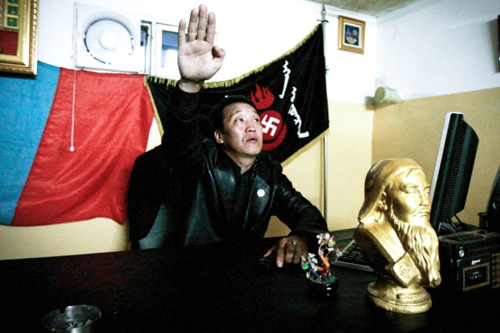 Ariunbold Altankhuum, leader of White Swastika, salutes in Ulan Bator. Members dress in black and sport swastika tattoos. Photo: AFP
