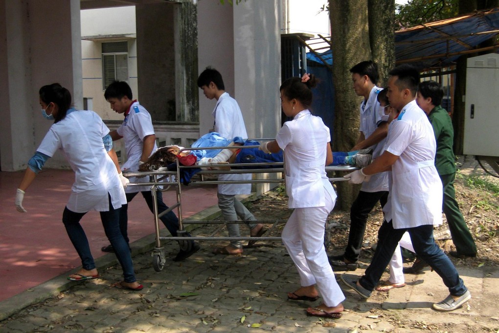 Hospital staff take away a victim after the explosions. Photo: AFP