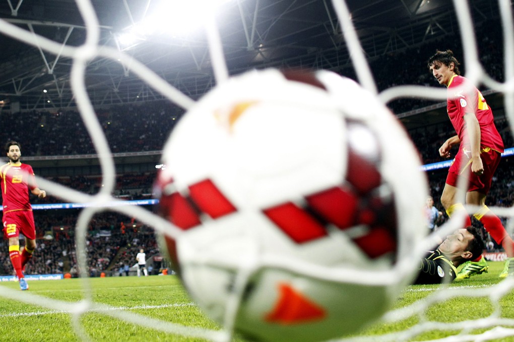 The ball hits the back of the net after a Wayne Rooney strike in England's 4-1 win over Montenegro. Photo: AFP