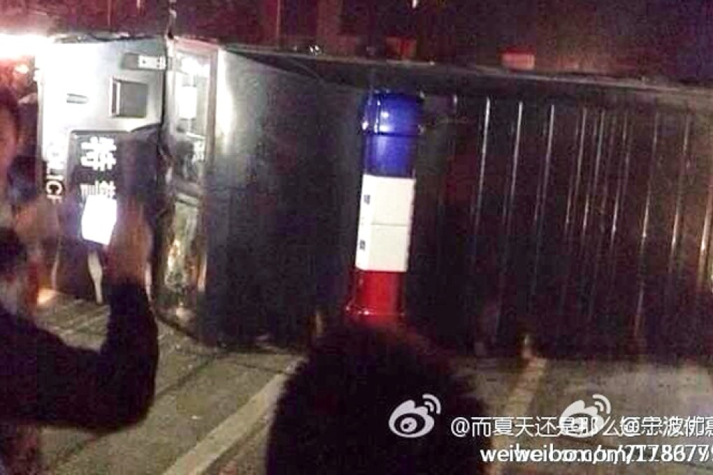 A police car was flipped by angry locals in Yuyao. Photo: Weibo screenshot