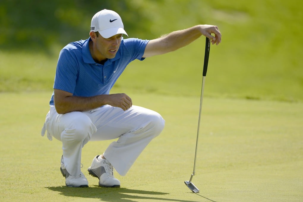Charl Schwartzel of South Africa lines up a putt during the final round of the Nanshan China Masters. Photo: AFP