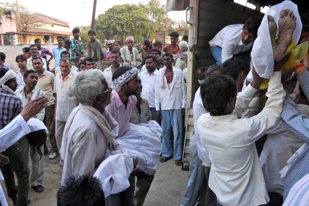 Bodies of Hindu worshippers are loaded onto a truck after the stampede. Photo: AFP