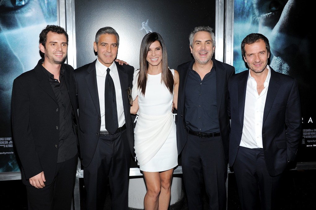 Screenwriter Jonas Cuaron, actor George Clooney, actress Sandra Bullock, director Alfonso Cuaron and producer David Heyman pose together at the premiere of "Gravity". Photo: AP
