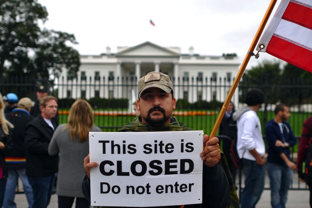 A protester holds a sign during a demonstration in front of the White House. Photo: AFP