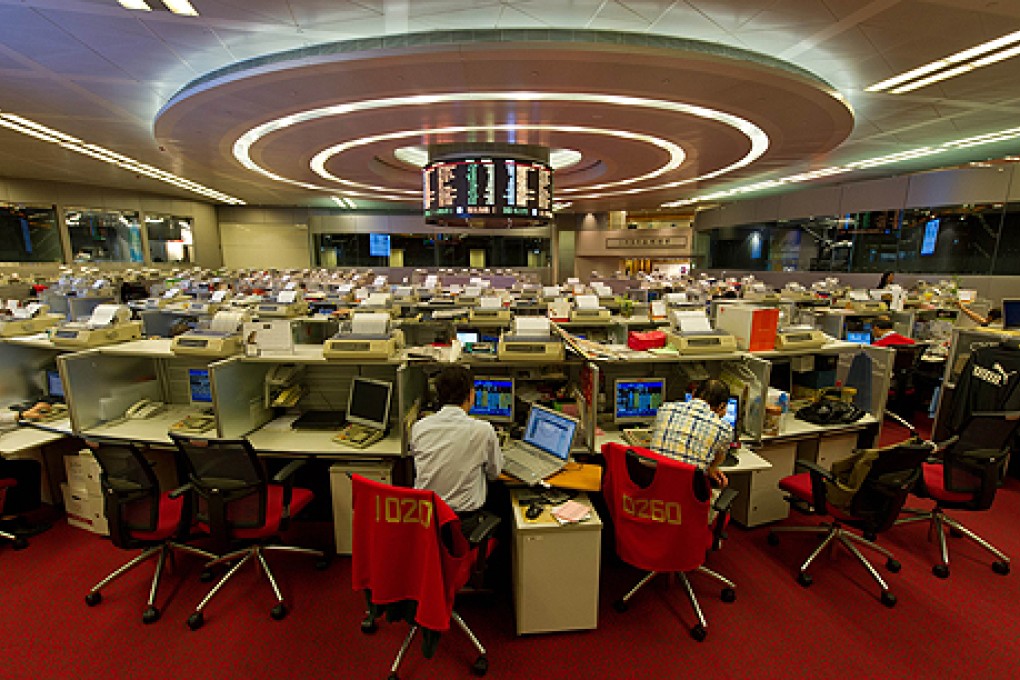 Traders work on the floor of the Hong Kong Stock Exchange. Photo: AFP