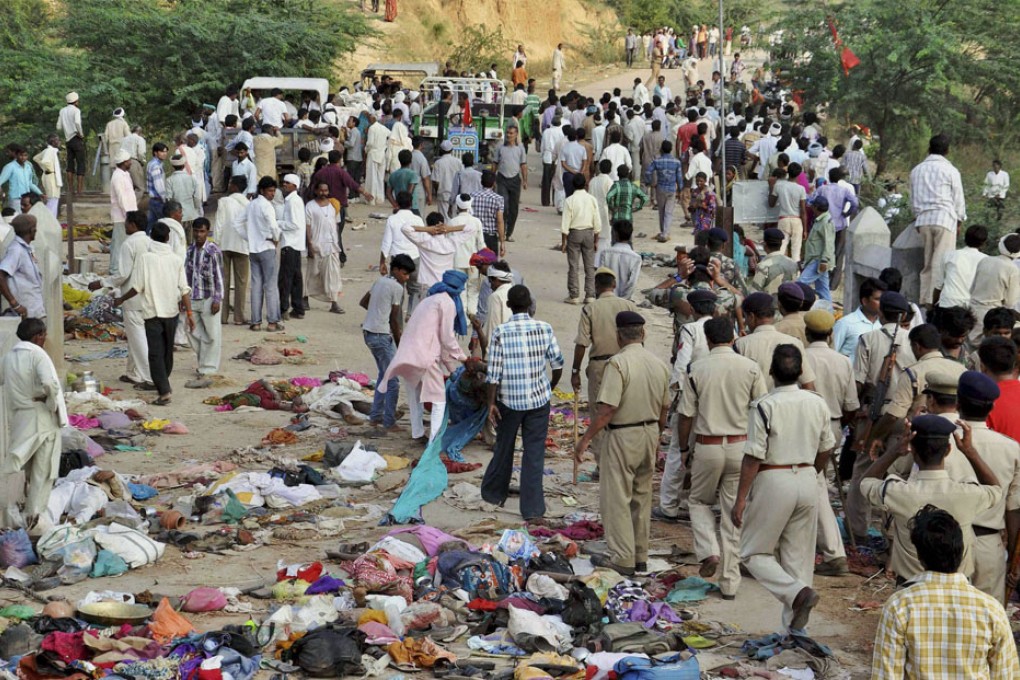 Indian villagers gather as policemen arrive at the scene of a deadly stampede on a bridge across the River Sindh.