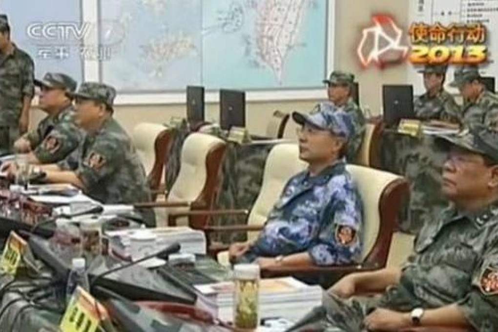 Soldiers of the People's Liberation Army oversee military exercises while a map of Taiwan prominently hangs in the background. Photo: SCMP Pictures