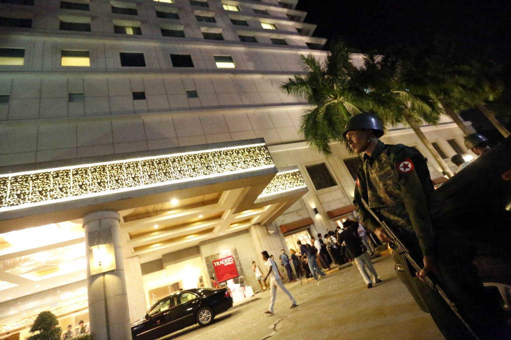 A soldier in front of the Traders Hotel after an explosion in central Yangon, Myanmar. Photo: Xinhua