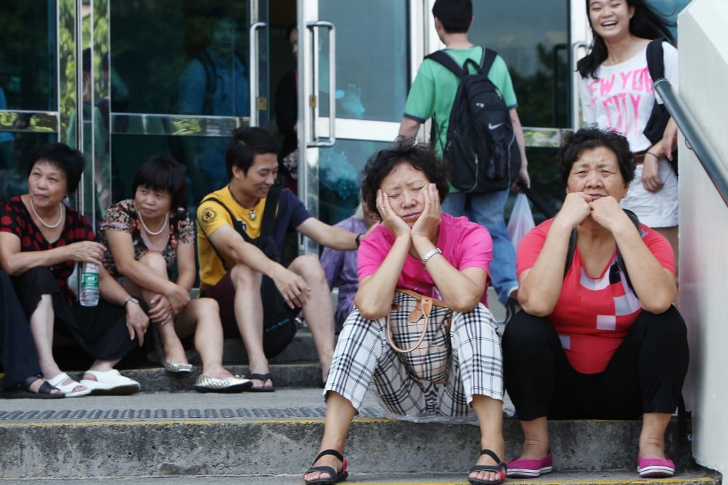 Mainland tourists take a break at Golden Bauhinia Square, where seats and alfresco dinning are not available. Photo: Nora Tam