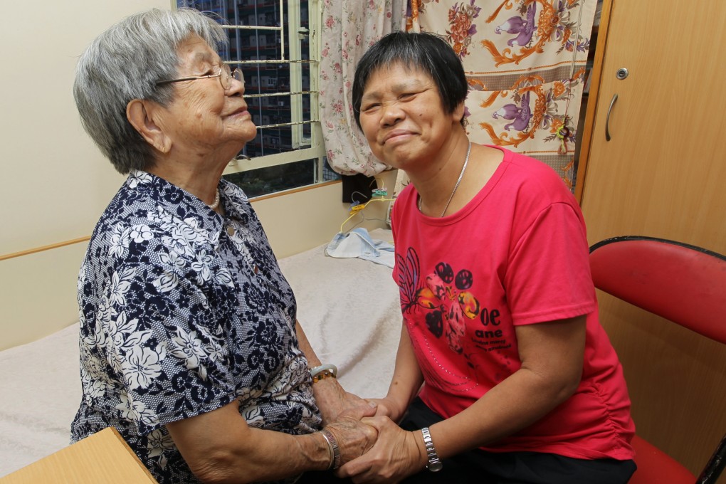 94-year-old Shek Man-kiu (left) is seen with Mak Kam-fung (right) who has been a Helping Hands employee for 15 years and a volunteer for six years Photo: Edward Wong