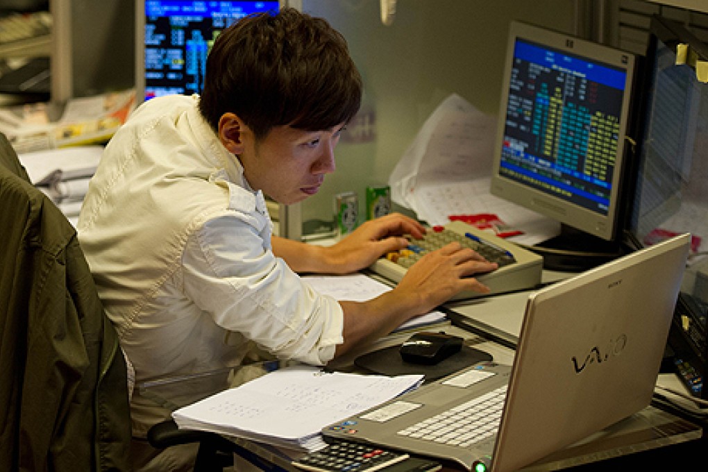 A trader works on the floor of the Hong Kong Stock Exchange. Photo: AFP