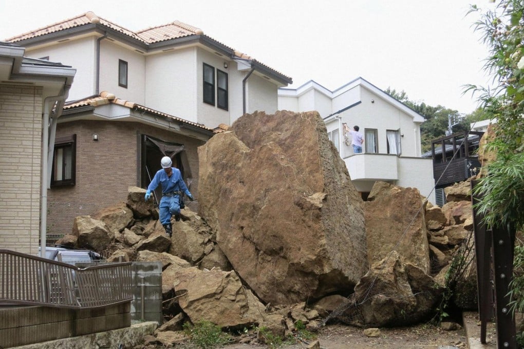 A landslide caused by Typhoon Wipha dropped huge rocks in front of this house in Kamakura, south of Tokyo. Photo: Reuters