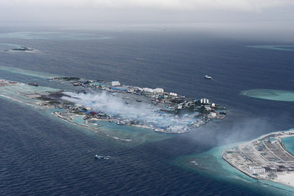 Smoke rises from the Maldives' largest rubbish dump on Thilafushi Island not far from the capital Male. Photo: AFP