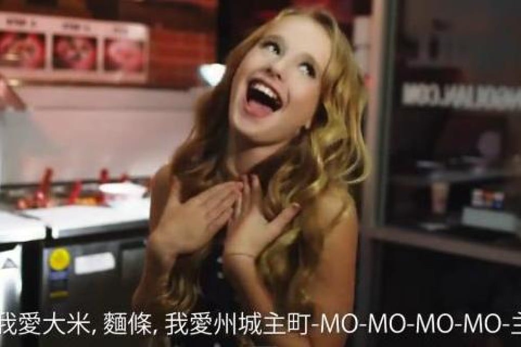 A still from the music video, with Alison Gold singing in a Chinese restaurant. Photo: SCMP Pictures
