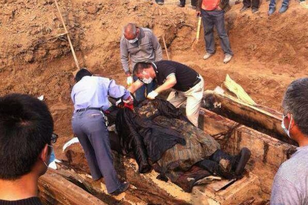 Photos from Henan Satellite TV show the body under examination by cultural-heritage officials. Photo: Xinhua