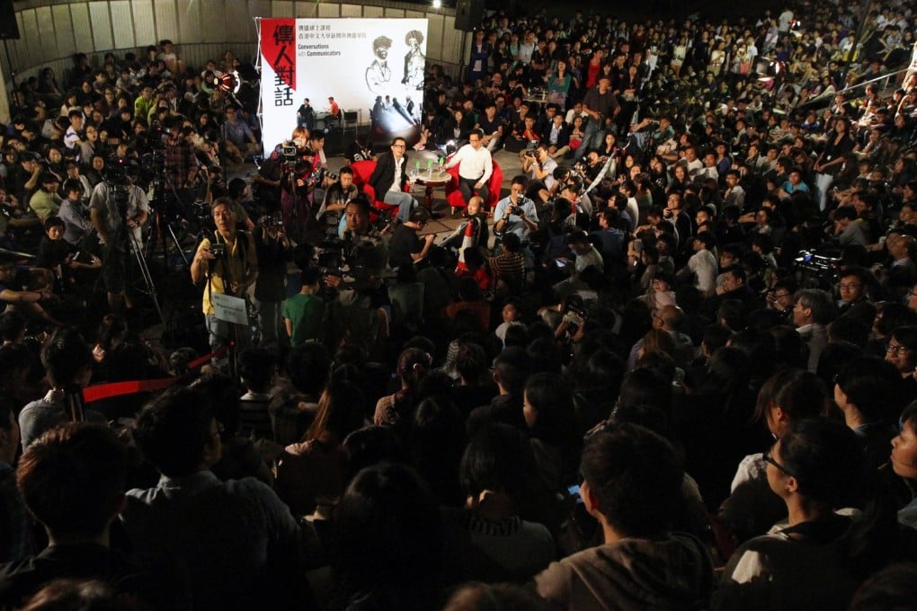 Ricky Wong sits amid 2,000 students and teachers at the open-air auditorium at Chinese University last night. Photo: Felix Wong