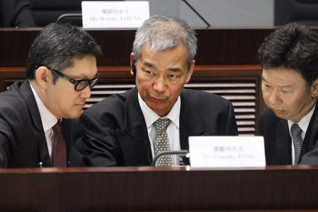 Lawyer Peter Wong (left) consults with Timothy Tong.