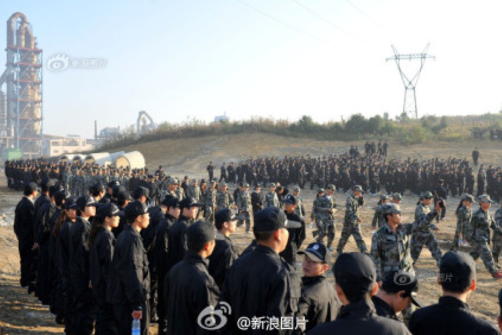 Students seen marching during a demolition operation in Guiyang. Screenshot via Sina Weibo.