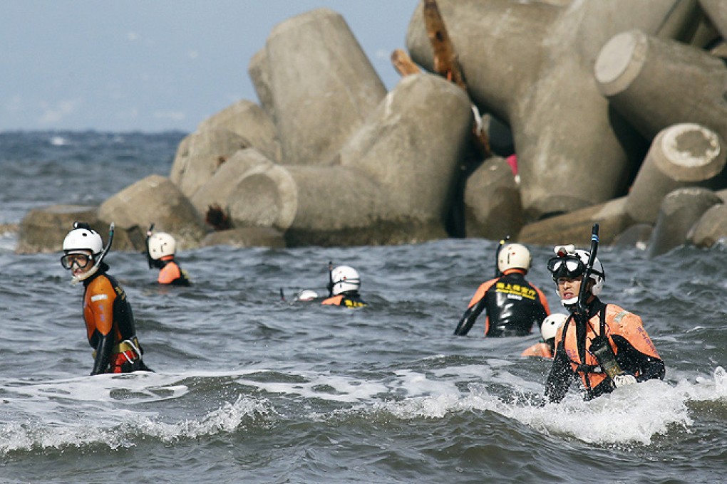 Frogmen join body hunt as Japan typhoon tolls hit 24 | South China