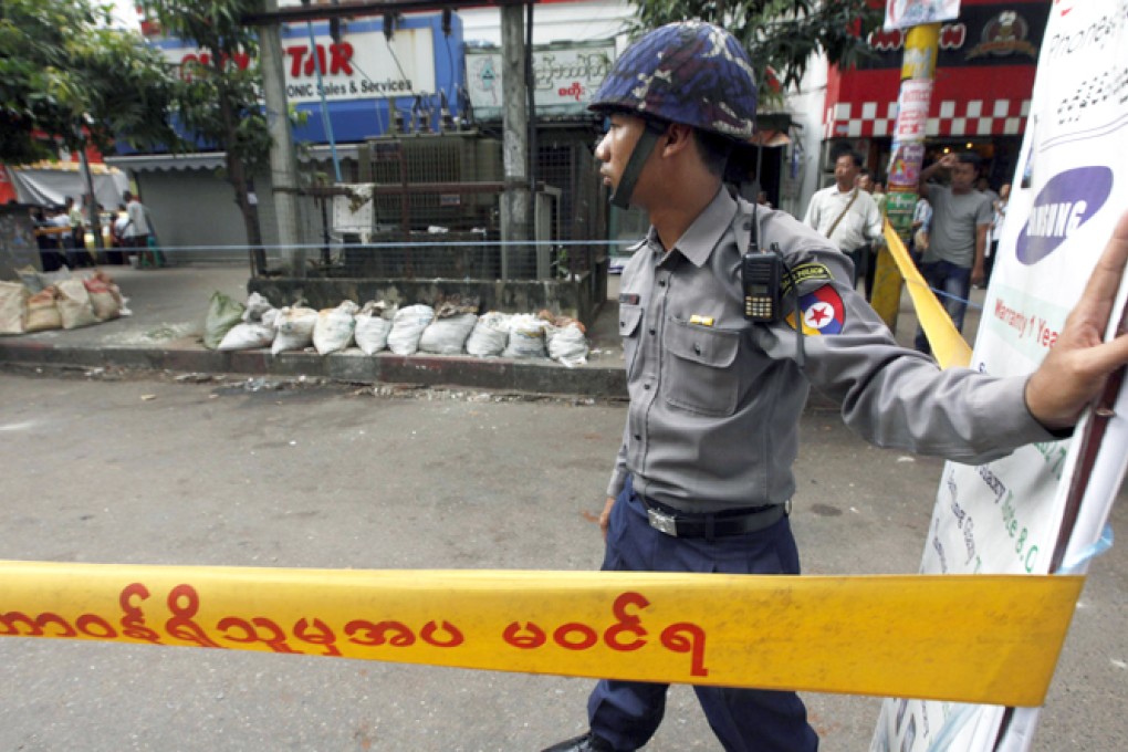 A policeman on bomb alert in central Yangon. Photo: AP