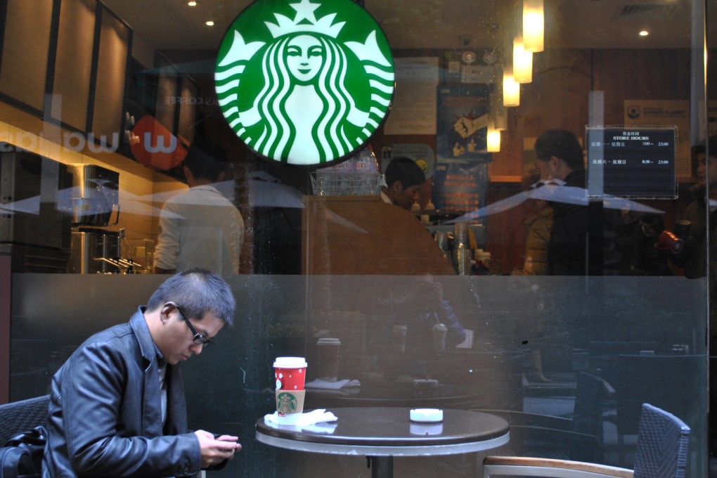 A man takes a rest at a Starbucks outlet in Shanghai. Photo: Xinhua