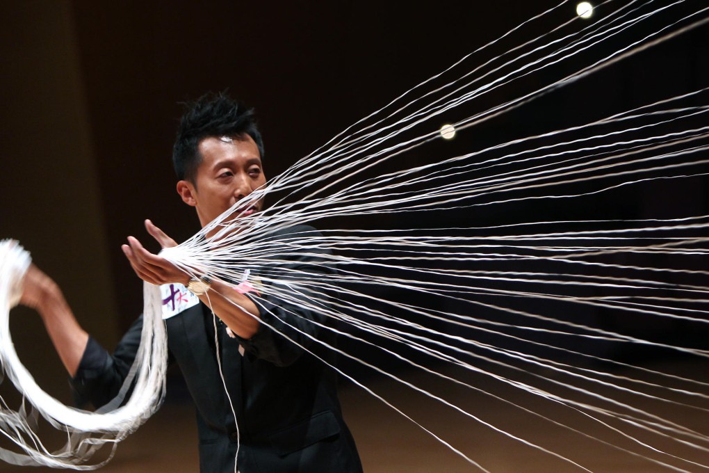 Illusionist Avon Lee shows why he is at the top of his game yesterday with a nifty bit of sleight of hand. Photo: Jonathan Wong